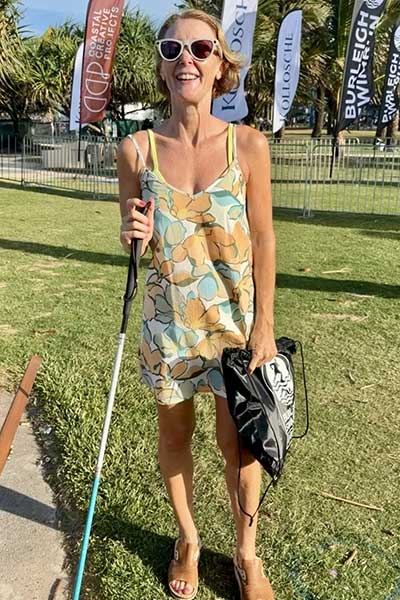 Joanne at an outdoor event with cane