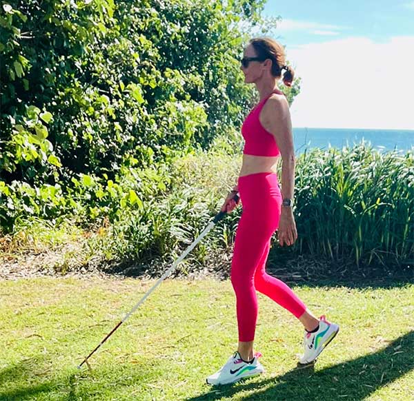 sporty woman walking with a cane