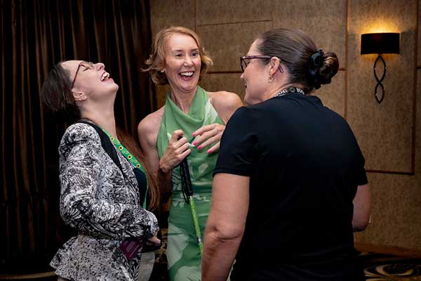 3 woman laughing at the empower her event 2026