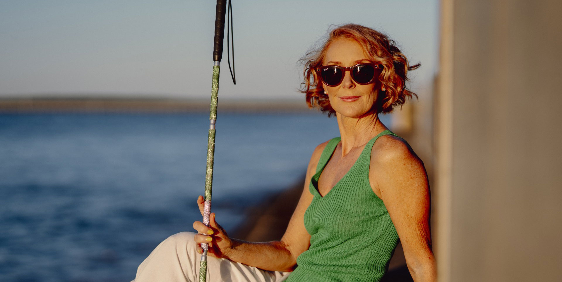 Joanne posing with her cane at sunset