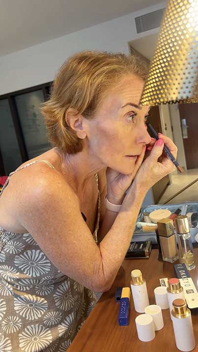 Joanne putting on makeup