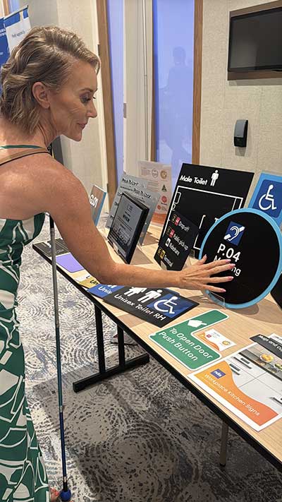 Joanne with Braille Tactile Signs Products