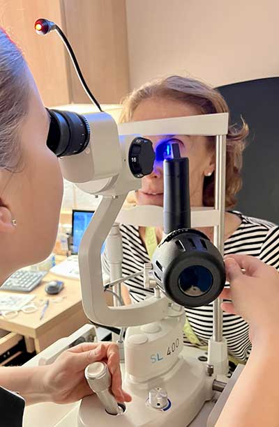 optometrist looking at eye through machine