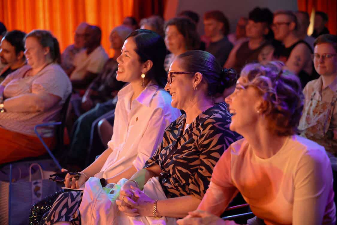 spectators sitting and watching at community get together